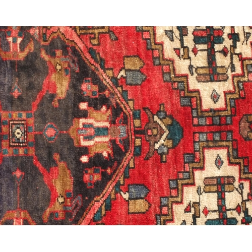 2096 - Rectangular Persian Backhtiar rug, having all over geometric motifs onto a predominantly red ground,... 