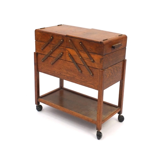 53 - Vintage oak cantilever sewing trolley and contents, 57cm high