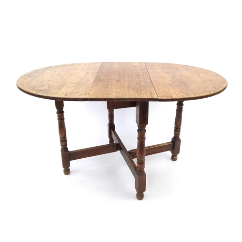 51 - 1930's oak drop leaf table on baluster turned legs, 74cm high x 140cm wide(open) x 90cm deep