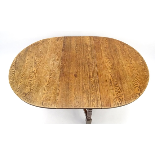 51 - 1930's oak drop leaf table on baluster turned legs, 74cm high x 140cm wide(open) x 90cm deep