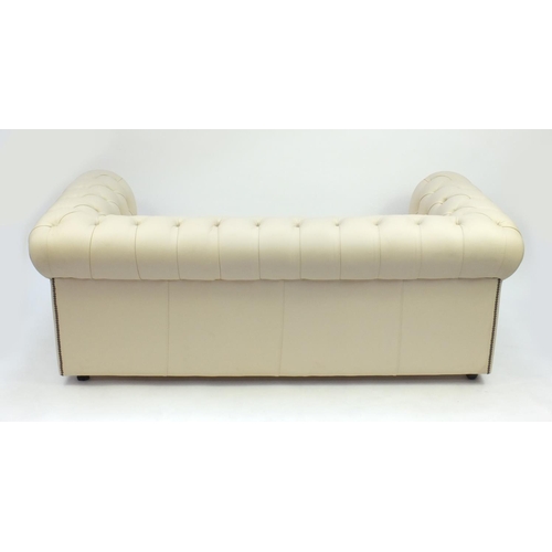 2009 - Cream leather three seater Chesterfield setee with button back upholstery, 70cm high x 190cm wide x ... 