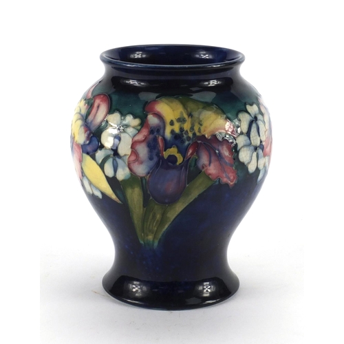 712 - Moorcroft Orchid pattern baluster vase, onto a blue ground, factory marks to the base, 15.5cm high