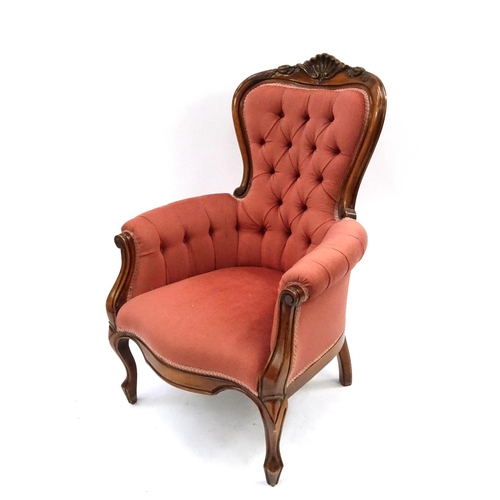 11 - Victorian style walnut framed reading chair with shell crest and salmon button back upholstery, 103c... 