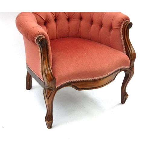 11 - Victorian style walnut framed reading chair with shell crest and salmon button back upholstery, 103c... 