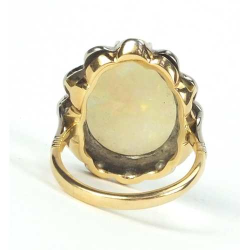 903 - 18ct gold opal and diamond ring set with twelve diamonds, size N, approximate weight 7.7g