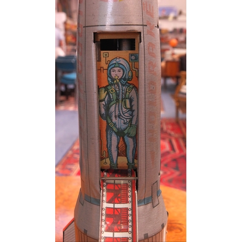 238a - 1950's tin plate toy rocket with wind up mechanism demonstrating a landing sequence, 40cm high