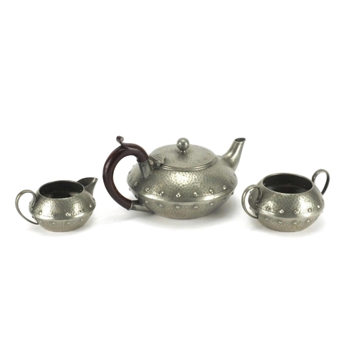 421 - Arts & Crafts style Homeland pewter three piece tea service with planished decoration