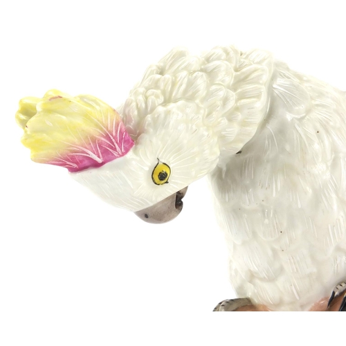 435 - Continental hand painted porcelain model of a cockatoo, blue under glaze factory marks to the base, ... 