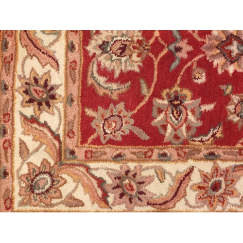 65 - Red and beige ground floral rug, 152cm x 91cm