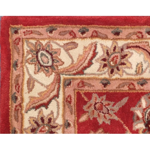 65 - Red and beige ground floral rug, 152cm x 91cm