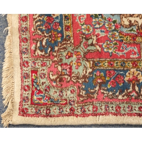 34 - Rectangular Persian Kerman rug with floral design onto a predominantly beige and pink ground, 225cm ... 