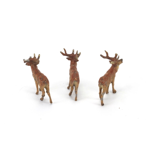 305 - Three hand painted lead stags, 6cm H