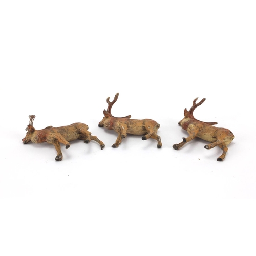 305 - Three hand painted lead stags, 6cm H