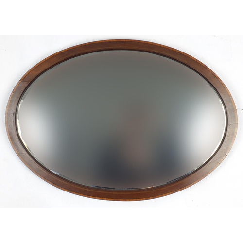 116 - Edwardian inlaid mahogany oval mirror with bevelled plate and one other oval bevelled edge mirror, t... 