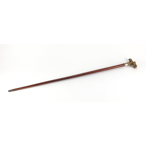 161 - Exotic wood walking cane with silver collar and brass dragon handle, 84cm L