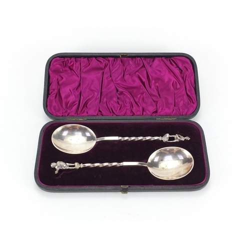 266 - Pair of silver plated apostle spoons with figural terminals, housed in a velvet lined leather case