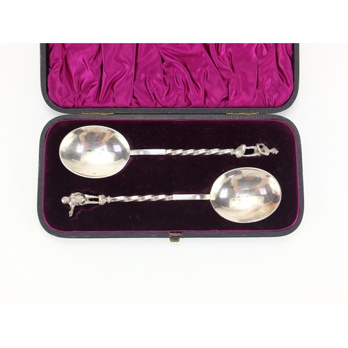 266 - Pair of silver plated apostle spoons with figural terminals, housed in a velvet lined leather case