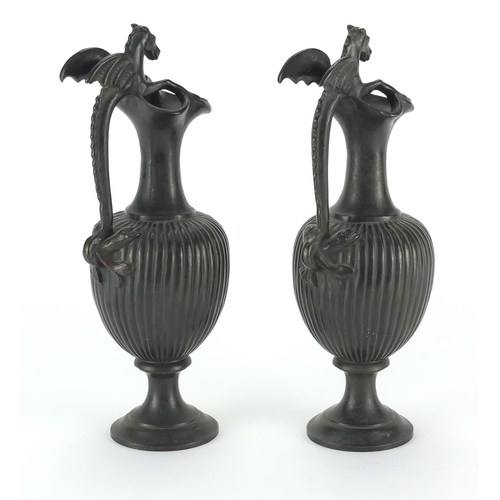 159 - Pair of bronze ewers with mythical animal handles, each 25.5cm H