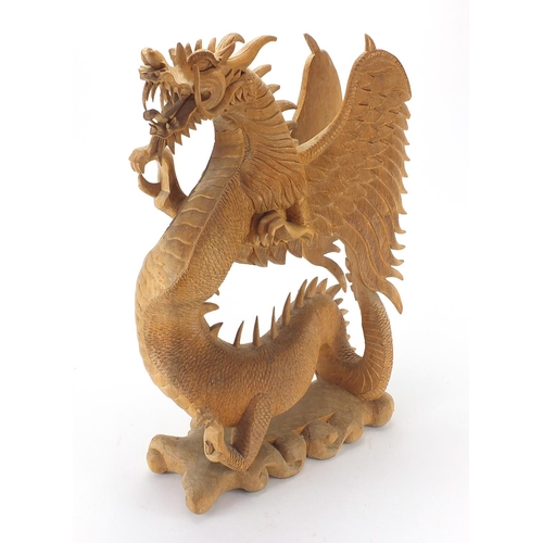 101 - Large carved wooden sculpture of a Chinese dragon, 60cm H