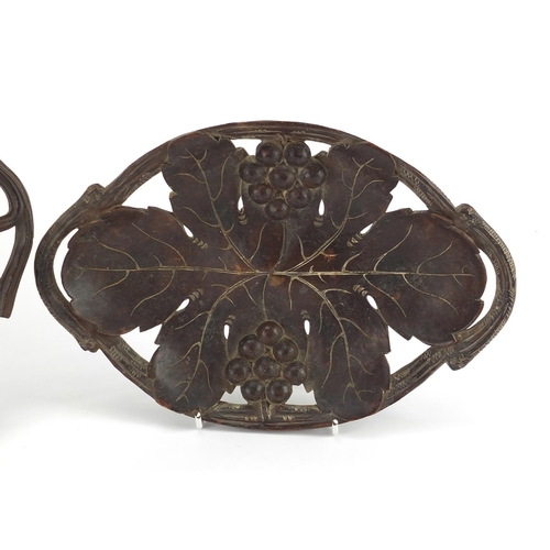 12 - Two black forest baskets, both carved with leaves and berries, the largest 36cm wide