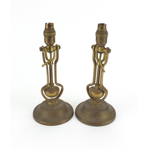 33 - Pair of Playmit brass gimbal lamps, impressed AP9009 to the bases, each 31cm high