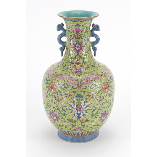 243 - Chinese porcelain vase with mythical twin handles, profusely hand painted in the famille rose palett... 