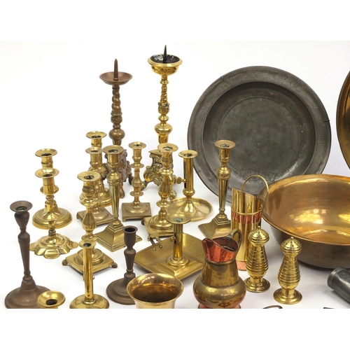 229 - Large selection of antique and later brass candle sticks, pewter plates and tankards etc