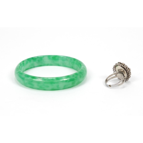 317 - Chinese green jadeite bangle, 7.5cm in D and a jadeite ring set with clear stones