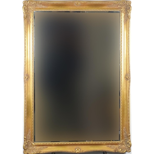52 - Rectangular ornate gilt framed bevelled edge mirror, 104cm x 74cm