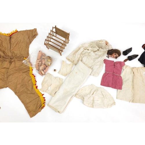 200 - Bisque head doll with open close eyes, with a selection of clothing including leather shoes