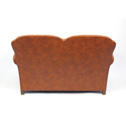 9 - Art Deco mottled brown leather oak framed two seater settee with serpentine front, 82cm H x 125cm W ... 