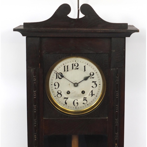 287 - Oak cased wall hanging striking clock with visible pendulum, 82cm L