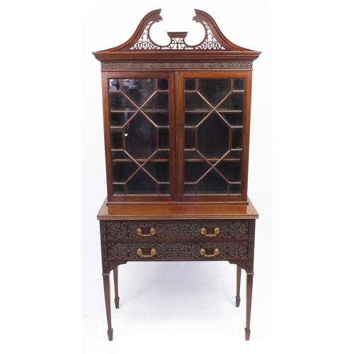 2003 - Chippendale style mahogany book case on stand, with swan neck pediment above a pair of astragal glaz... 