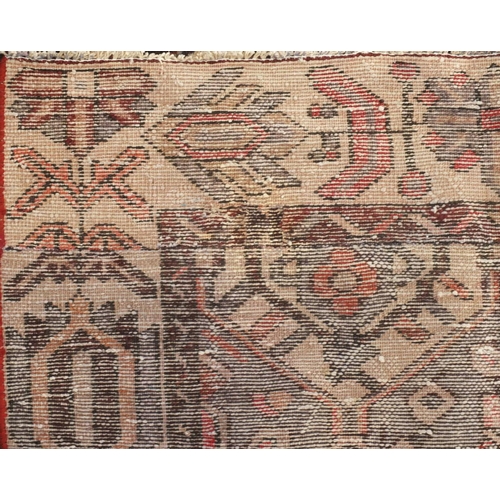 18 - Rectangular Persian Azarbaijan rug, the central field and borders having all over floral motifs onto... 