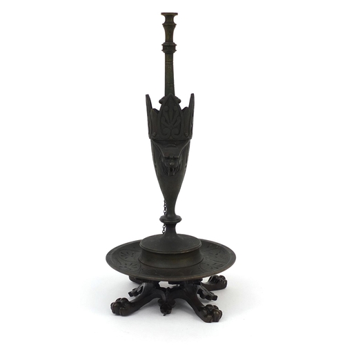 303 - Victorian bronze oil lamp with masks and lion paw feet, 25cm high