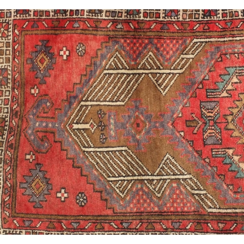 47 - Rectangular Persian Arak carpet runner, having an all over geometric design onto a predominantly red... 
