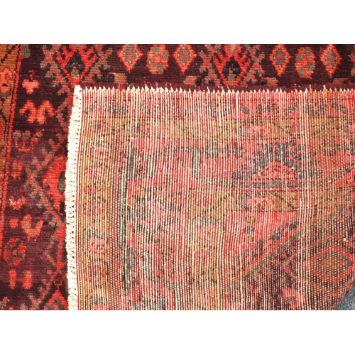 75 - Rectangular Persian Hamadan rug, the central field having all over floral motifs, onto an red and pu... 