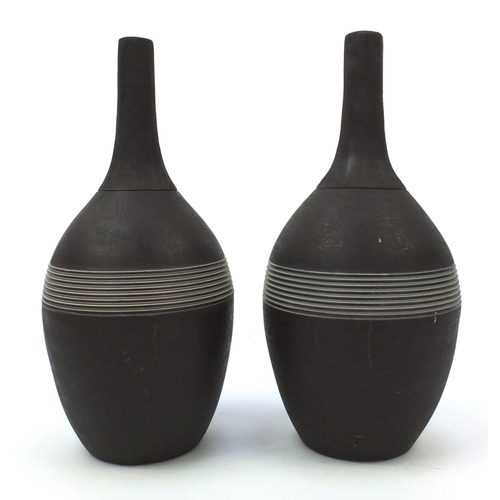 276 - Pair of long necked bottle vases with incised decoration, each 44.5cm high