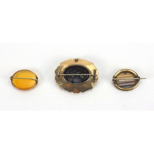 250 - Three vintage brooches comprising a large gilt metal black enamel and seed pearl example, the others... 