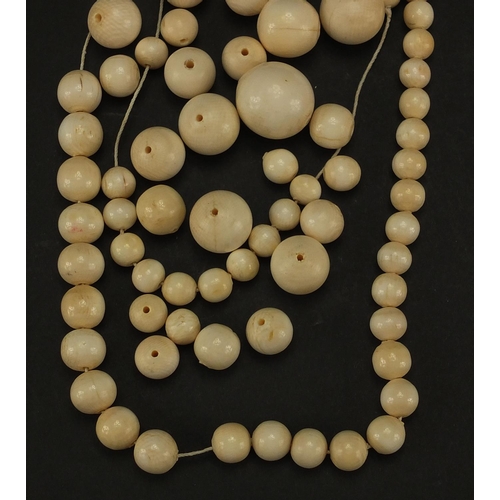 307A - Group of ivory beads with gold coloured metal clasp, the largest bead 2.4cm in D