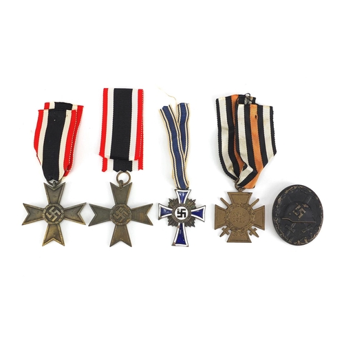 199 - German Military interest medals and badges comprising mothers cross, Merit Cross, Wounds badge and C... 