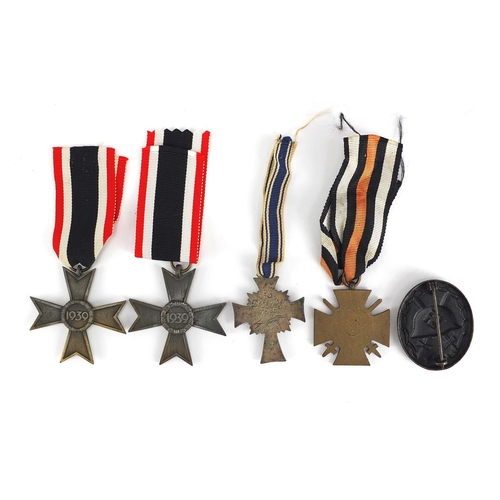 199 - German Military interest medals and badges comprising mothers cross, Merit Cross, Wounds badge and C... 