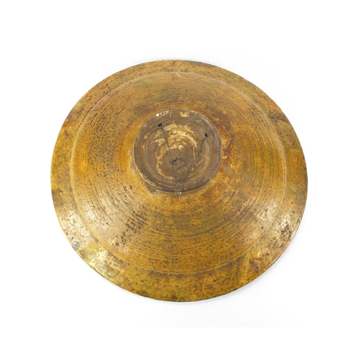 468 - Large Victorian treacle glazed pottery charger, 44cm in diameter