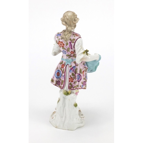 434 - 19th century continental porcelain figure of a fruit seller hand painted with flowers, factory marks... 