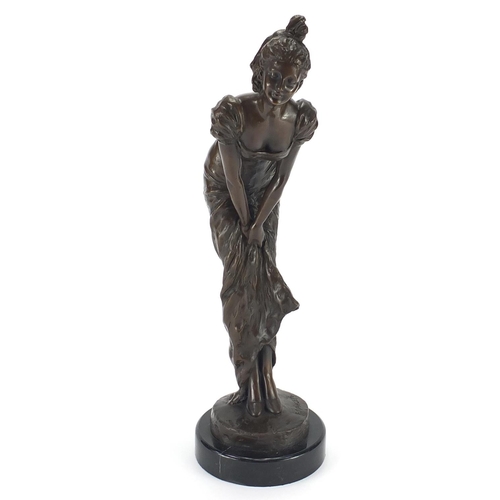 2098 - Bronze study of an Art Deco female holding her dress, raised on a circular marbleised base, signed E... 