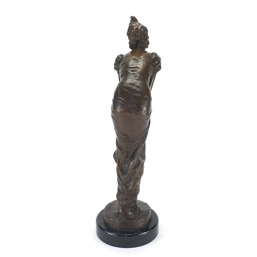 2098 - Bronze study of an Art Deco female holding her dress, raised on a circular marbleised base, signed E... 