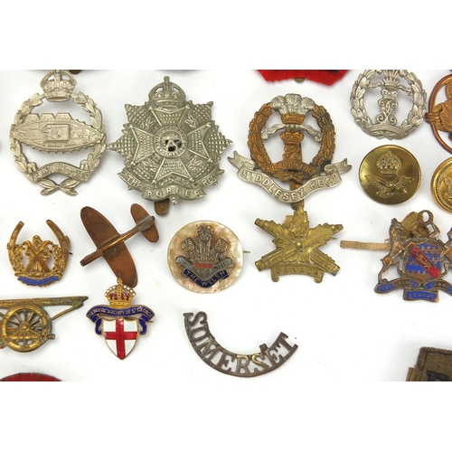 187 - Military interest cap badges, cloth insignia and a German medal including Sheffield University, Midd... 