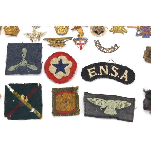 187 - Military interest cap badges, cloth insignia and a German medal including Sheffield University, Midd... 