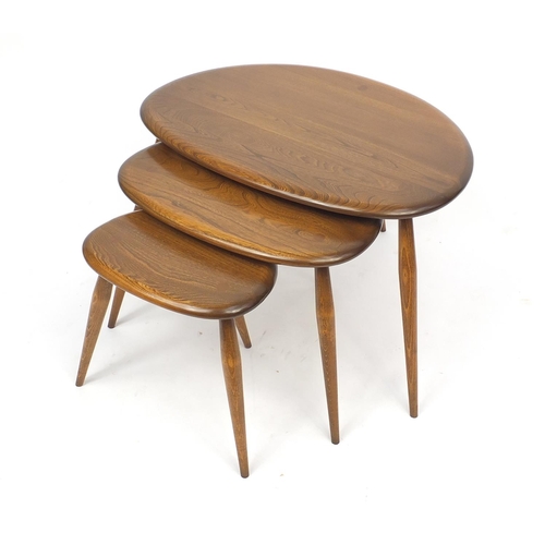 2028 - Ercol elm nest of three pebble tables, label to the inside of the larger, 40cm H