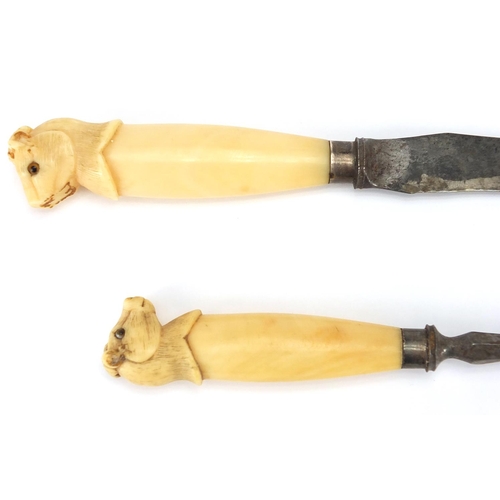 28 - Silver mounted ivory handled carving knife and fork, the animal  heads set with beaded glass eyes, t... 